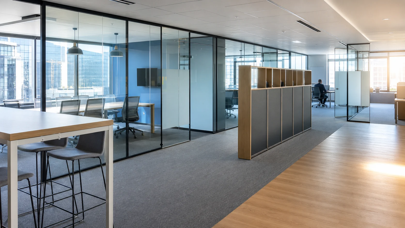 Glass-partitioned office with furniture obstructions and strong daylight