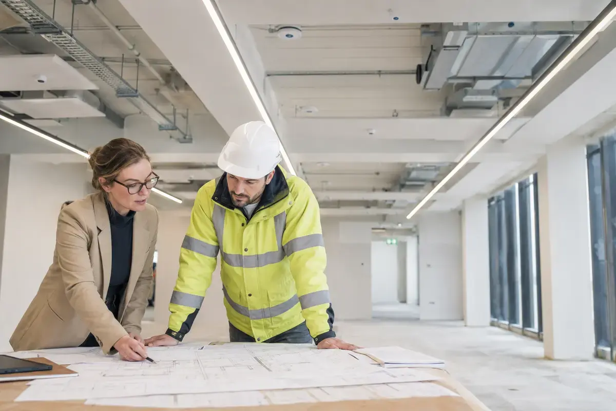 Architect and electrical engineer coordinating lighting and building services in a new commercial project