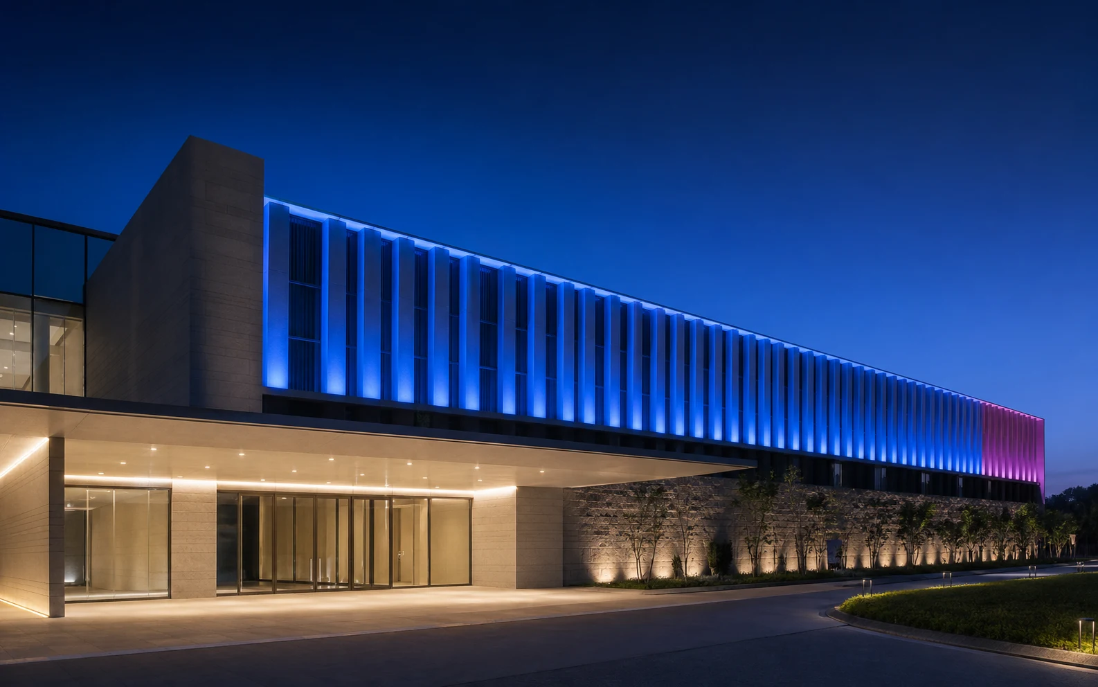 Architectural façade with uniform blue and restrained magenta lighting